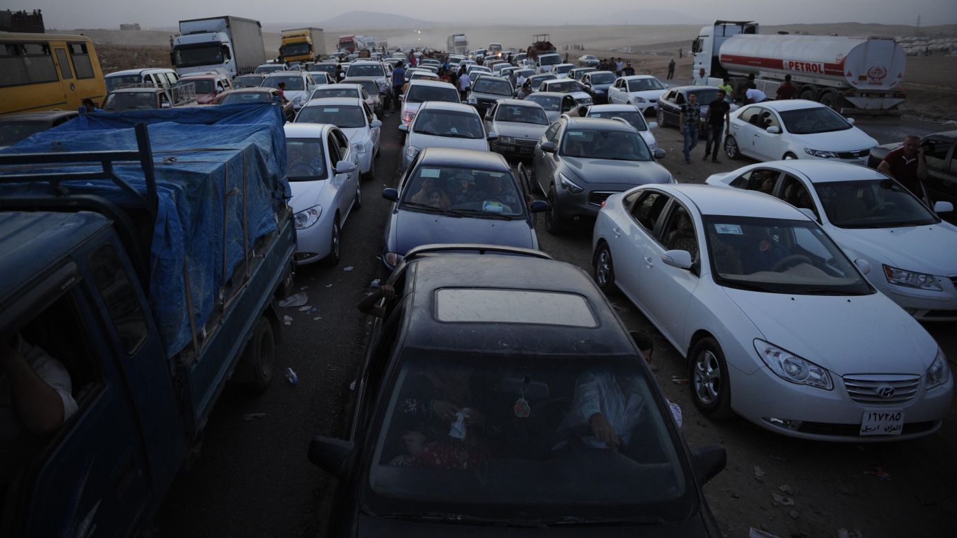 Thousands of Yazidi and Christian people flee Mosul, Iraq, on Wednesday, August 6, after the latest wave of advances by the militant group ISIS. ISIS -- known for killing dozens of people at a time and carrying out public executions, crucifixions and other acts -- <a href="http://www.cnn.com/2014/06/13/world/gallery/iraq-under-siege/index.html">has taken over large swaths of northern and western Iraq</a> as it seeks to create an Islamic state that stretches from Syria into Iraq.