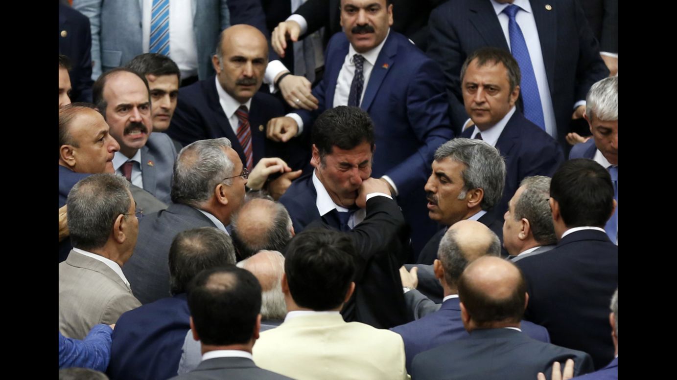 Muhyettin Aksak, a lawmaker from the ruling AK Party in Turkey, punches Sinan Ogan of the Nationalist Movement Party during a debate in parliament Monday, August 4, in Ankara, Turkey. Three members of parliament were injured when the debate turned into an all-out fistfight, the Dogan News Agency reported, and the session was adjourned. During the debate, the parties were discussing whether to establish an inquiry into the Islamist militants fighting in neighboring Iraq and Syria.