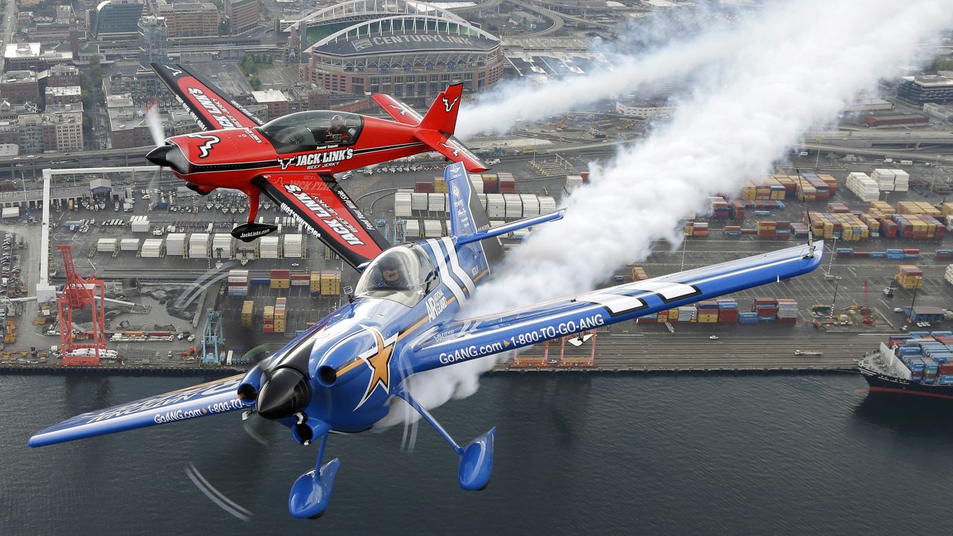 Pilots John Klatt, bottom, and Jeff Boerboon fly their planes in formation above Seattle on Saturday, August 2. The two performed that weekend in the Boeing Seafair Air Show.