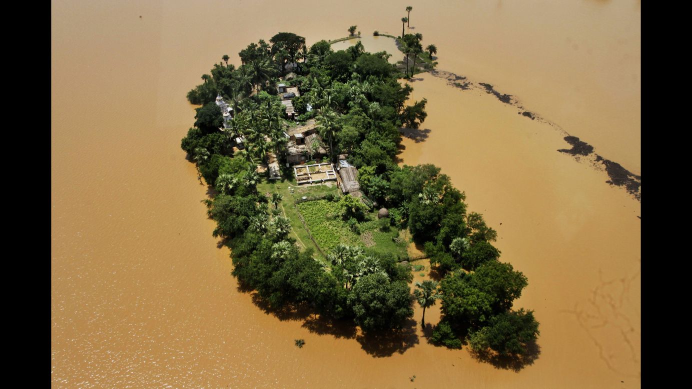 An aerial view shows houses cut off by monsoon floods Wednesday, August 6, in the Kendrapara District of eastern India. The annual monsoon season, which runs from June through September, is vital for the largely agrarian economies of South Asia, but it also brings floods and landslides that kill thousands and submerge hundreds of villages every year.
