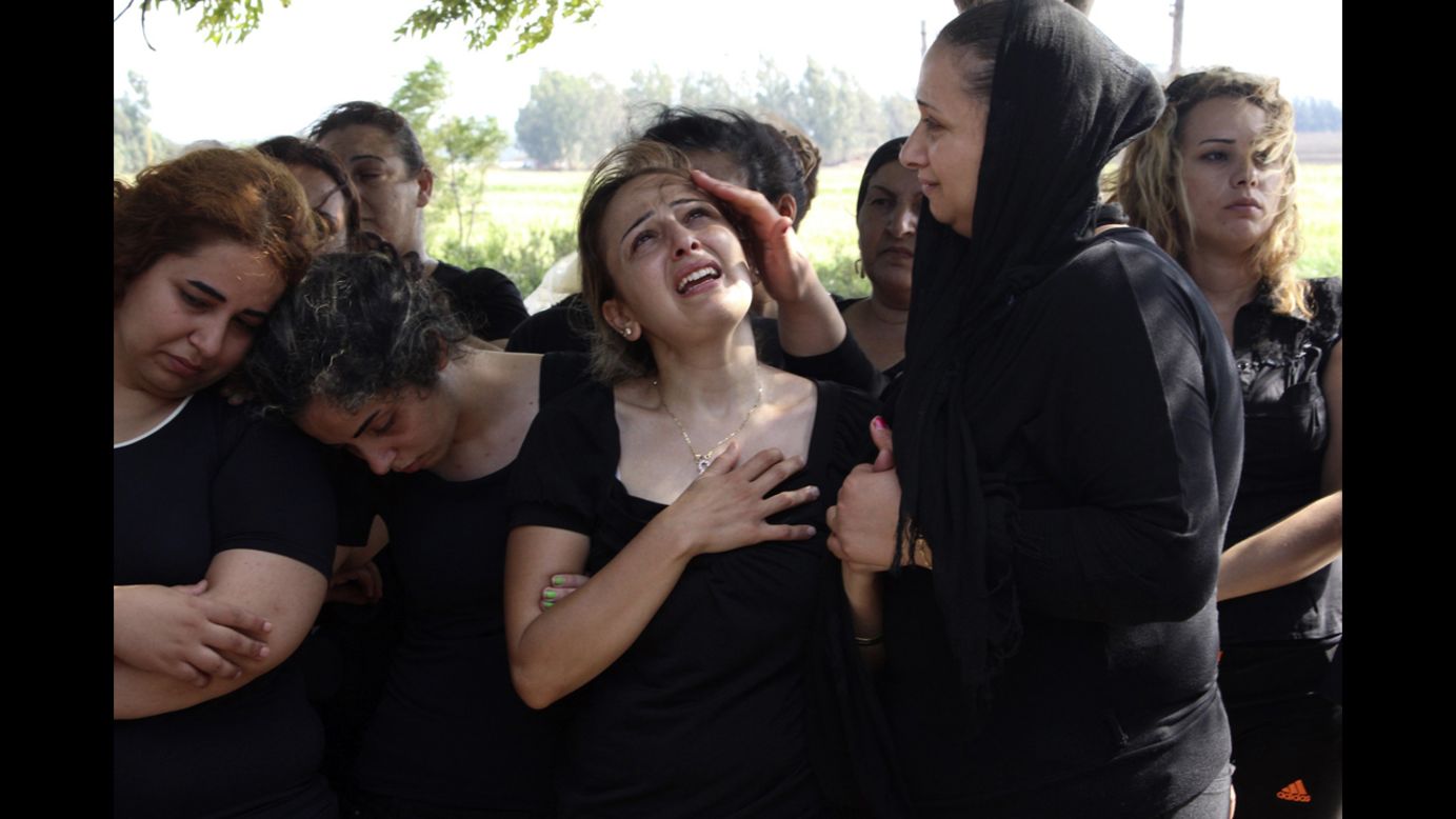 Relatives of Alawite soldier Ali Khaddaaro, who was killed during clashes between Lebanese Army soldiers and Islamist militants in Arsal, Lebanon, mourn during his funeral Tuesday, August 5, in Akkar, Lebanon.