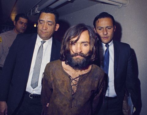 Manson is escorted to his arraignment on conspiracy-murder charges.