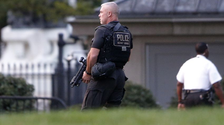 A member of the U.S. Secret Service Emergency Response Team (ERT) stands watch on the North Lawn at the White House in Washington, Thursday, Aug. 7, 2014. A brief security alert ensued when a child slipped through the gates of the White House, according to Secret Service officials. (AP Photo/Charles Dharapak)