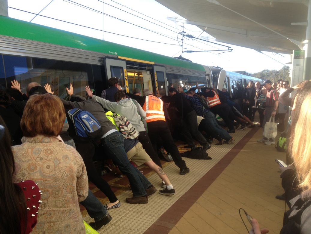 Dozens of commuters in Perth, Australia, work to rescue a man who got his leg trapped between a train and a platform on Wednesday, August 6. The passenger was able to wriggle free with their help.