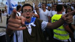An ultra-nationalist Israeli man gestures during the "flag march" through Damascus Gate in east Jerusalem on May 28, 2014.