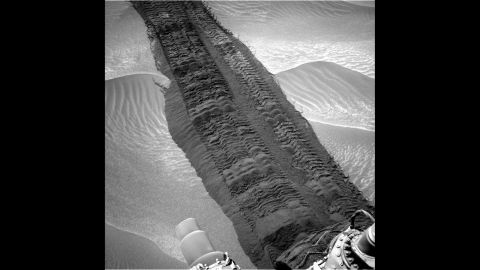 Wheel tracks from Curiosity are seen on the sandy floor of a lowland area dubbed "Hidden Valley" in this image.