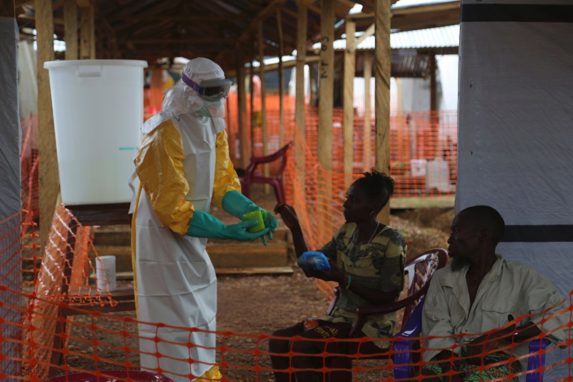 A health worker gives food to patients confirmed to have Ebola. At Kailuhun, 70% of the patients will die. Those who survive <a href="http://cnn.com/2014/07/10/world/africa/ebola-survivor-red-cross/">may face stigma from their communities.</a>