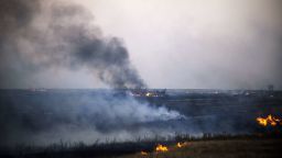Smoke billows from the flaming debris of a crashed Ukrainian fighter jet near the village of Zhdanivka, some 40 kilometres northeast of the rebel stronghold of Donetsk, eastern Ukraine, on August 7, 2014. 