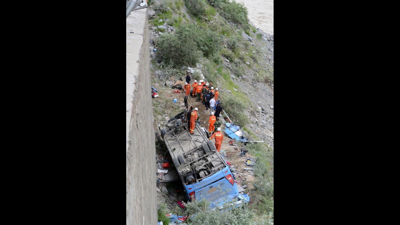 Workers attempt to use a crane to lift the bus after the accident.  China's Xinhua News Agency reported that it crashed in a pileup invovling a sports utility vehicle and a pickup truck. 