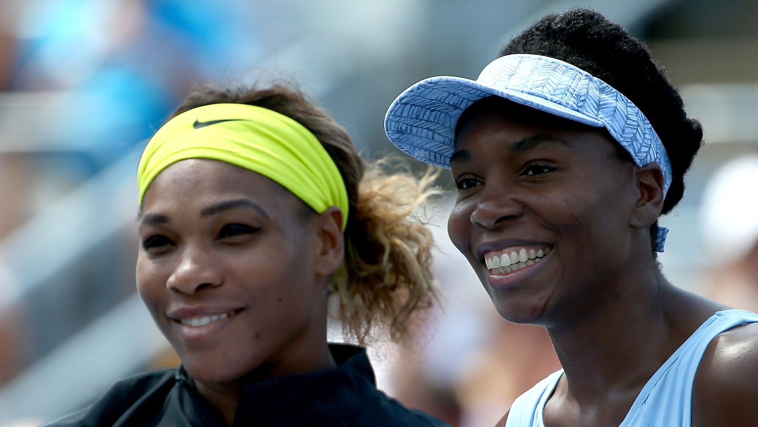 Serena and Venus Williams pose before their women's semifinals match in the Rogers Cup at Uniprix Stadium. 