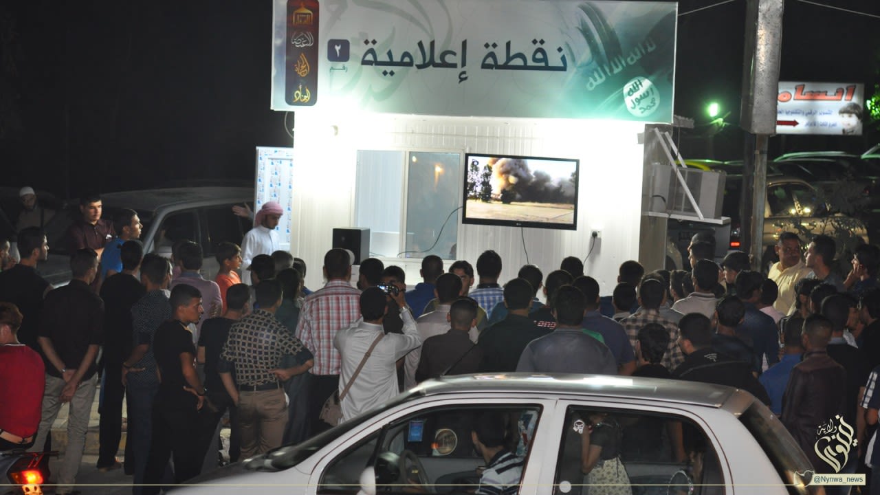 A video is shown to residents at an ISIS propaganda information center in Mosul, Iraq.