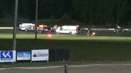 This image provided by Logan Messerly shows ambulances on the scene at Canandaigua Motorsports Park on Saturday Aug. 9, 2014 in Canandaigua, N.Y. Authorities are investigating a serious crash that injured one person at a New York dirt track where Tony Stewart was racing on the eve of a NASCAR race. (AP Photo/Logan Messerly)