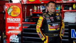 Driver Tony Stewart looks on in the garage area during practice for the NASCAR Sprint Cup Series Cheez-It 355 at Watkins Glen International on August 8n\, Watkins Glen, New York. Stewart is a three-time champion in NASCAR's top division and also won a sprint car championship in 1995.