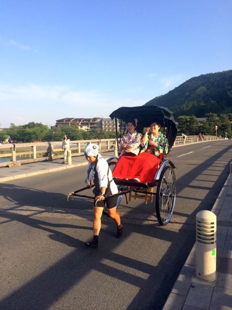 <strong>Retro rides: </strong>Kimono-clad Japanese tourists take a rickshaw ride over Arashiyama's Togetsukyo Bridge (Moon Crossing Bridge).