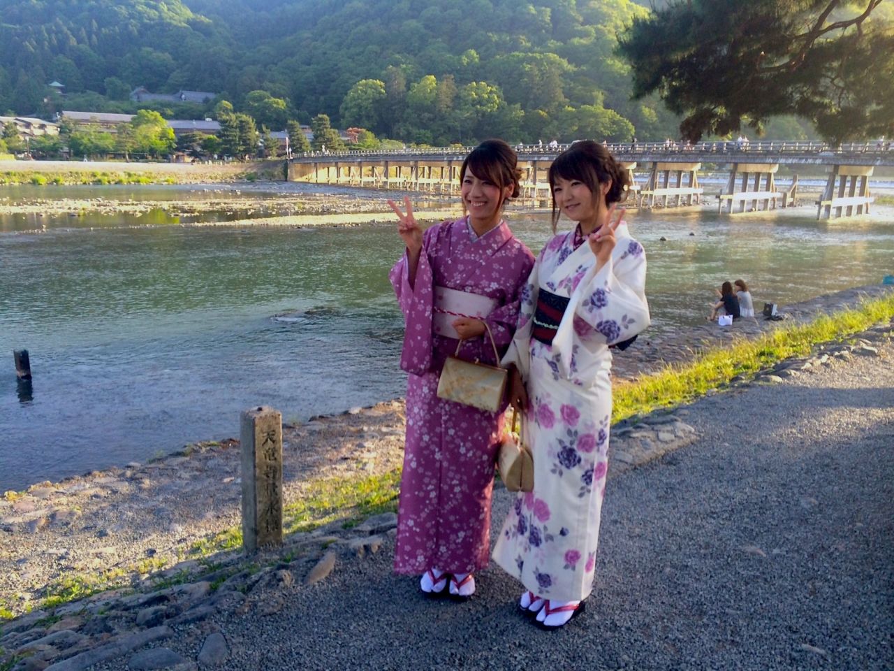 <strong>Local tourists: </strong>Kimono-clad Japanese tourists pose in front of Arashiyama's main icon, the Togetsukyo Bridge.  