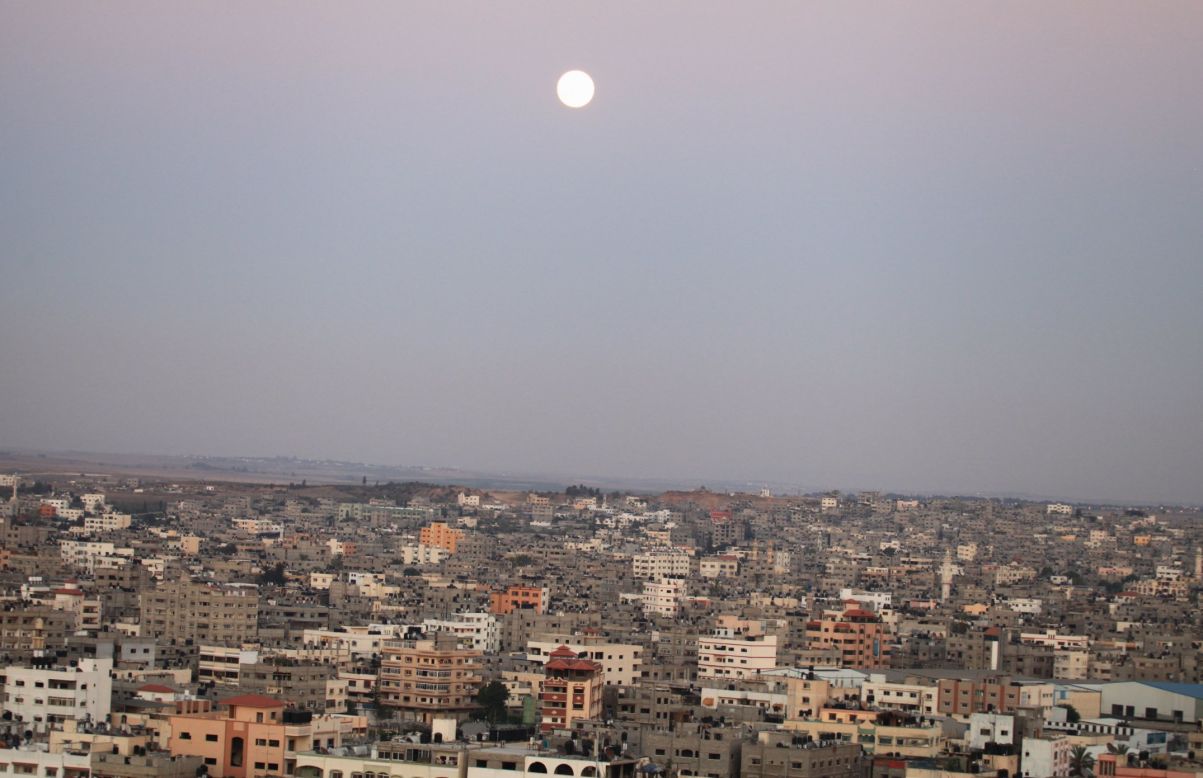 The moon rises over Gaza City.