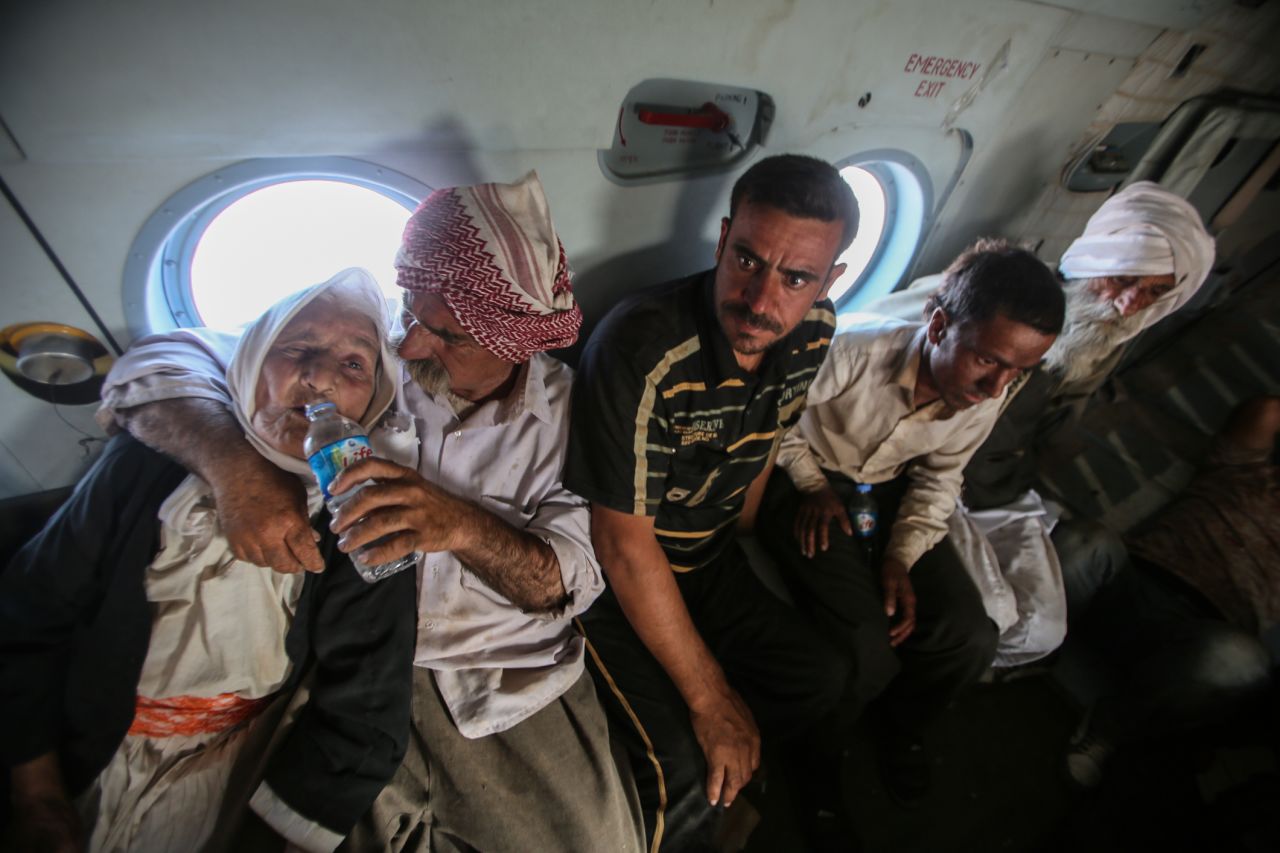 Rescued civilians sit on the helicopter.