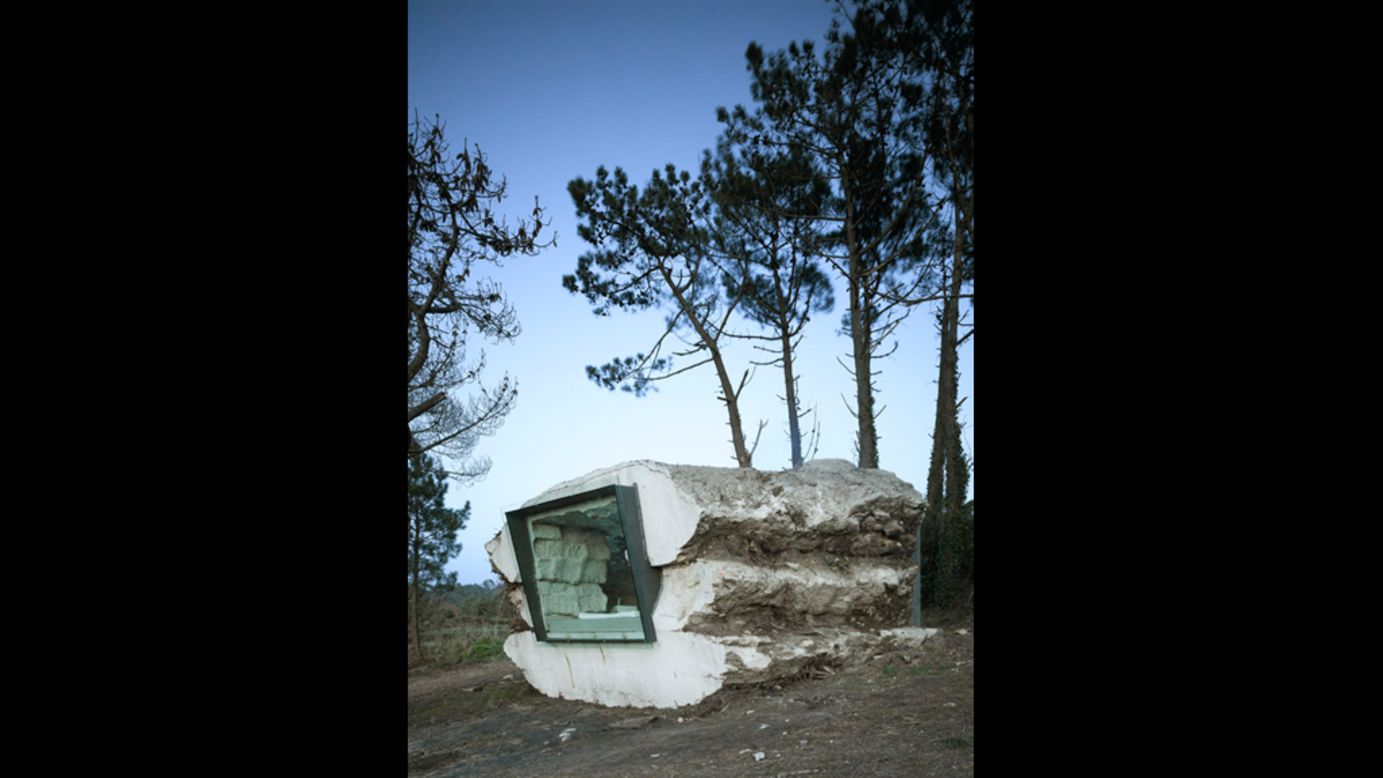 <em>The Truffle, Spain</em><br /><br />This rugged dwelling is described by designers <a href="http://www.ensamble.info/actualizacion/projects/truffle" target="_blank" target="_blank">Ensamble Studio</a> as a "piece of nature built with earth, full of air." So it's perhaps fitting that a calf called Paulina did much of the building work. Bales of hay were tightly stacked on the ground forming a mass that concrete was poured over. Once dry, cuts were made into the amorphous stone so that Paulina the calf could start eating the hay inside.<br /><br />It took her a year to get through the hay and when she was done, she had grown into a 300 pound adult. Ensamble turned the space she left into a hideout that is both organic and contemporary, with stunning views of the coastline of Galicia out of the window. <br />