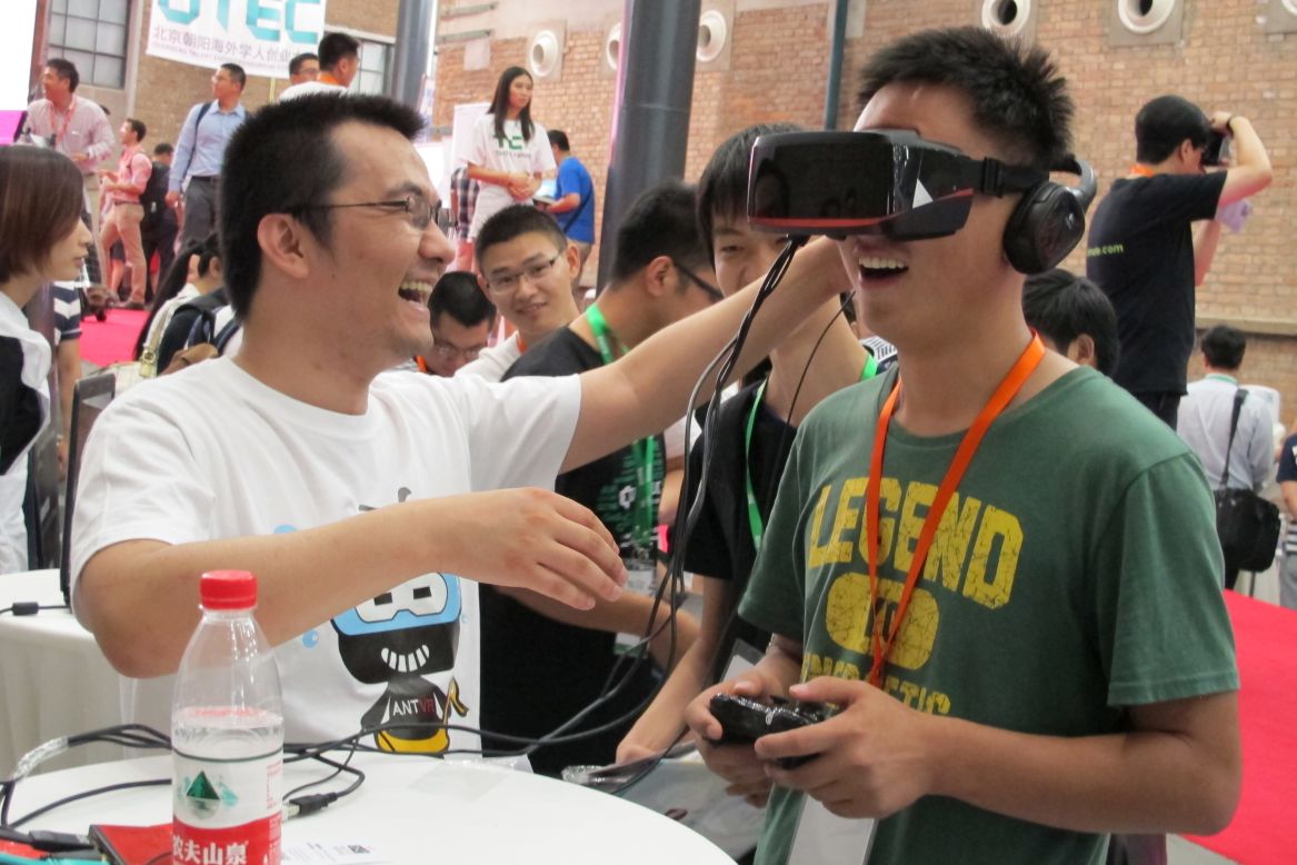 A visitor plays with a gaming helmet designed by Beijing-based company ANTVR. The device allows its user to fully immerse themselves in the virtual experience.
