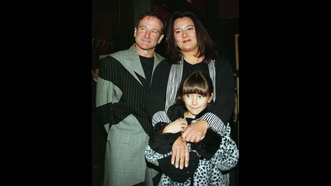 Williams and his wife, Marsha, pose for photographers with their daughter, Zelda, as they arrive at the premiere of the film "Patch Adams" in December 1998 in New York City. 