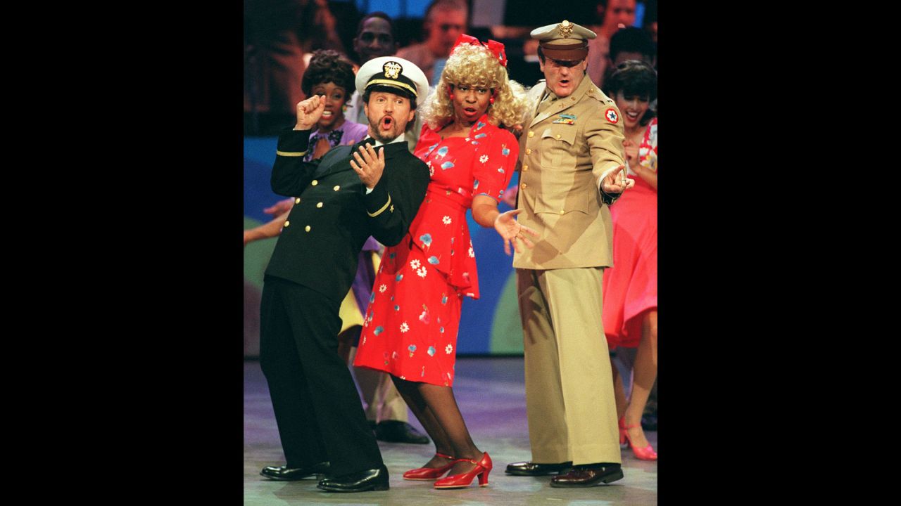 Comedians and co-hosts, from left, Billy Crystal, Whoopi Goldberg and Williams sing and dance the 1940s-era opening number to "Comic Relief VII" on November 11, 1995, in Los Angeles. 