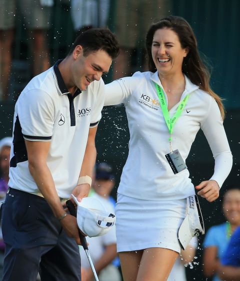 Kaymer is doused with water by fellow German and LPGA star Sandra Gal in June after adding to his 2011 PGA Championship triumph.