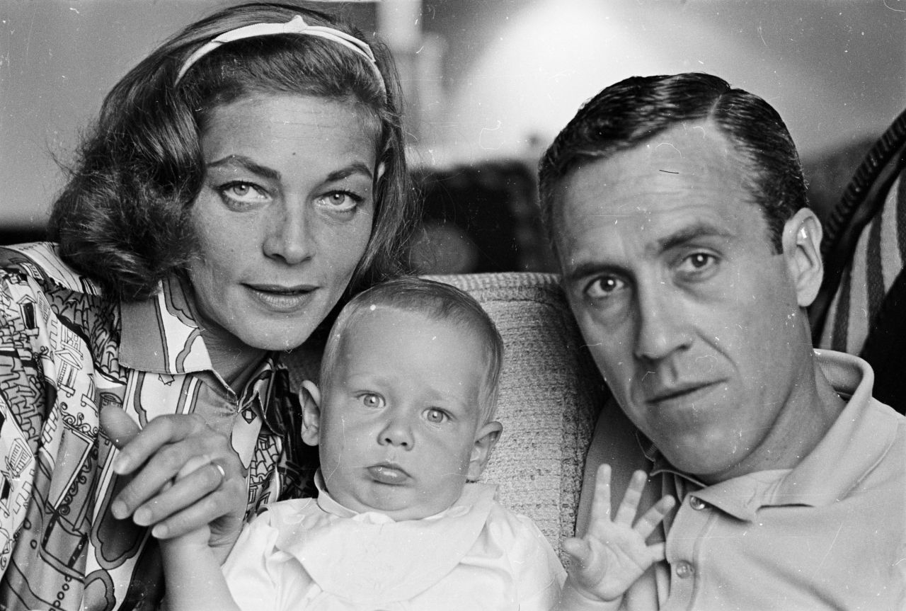 Bacall poses with her second husband, actor Jason Robards, and their baby son Sam in 1962.