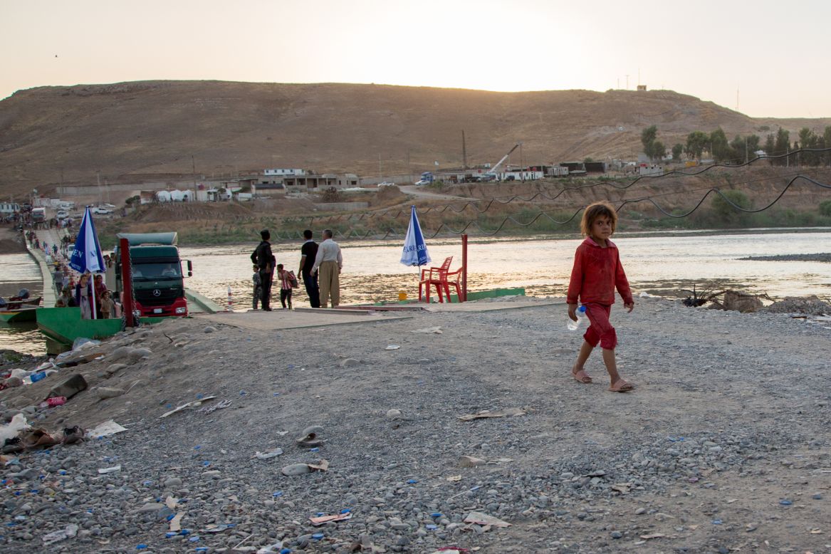 A little girl was seen crossing the bridge by herself.<a href="http://cnn.com/2014/08/12/world/meast/iraq-crisis/index.html"> The United States is sending more troops to northern Iraq,</a> a move that U.S. officials told CNN is necessary to help in the rescue of tens of thousands of Yazidis trapped in the mountains.