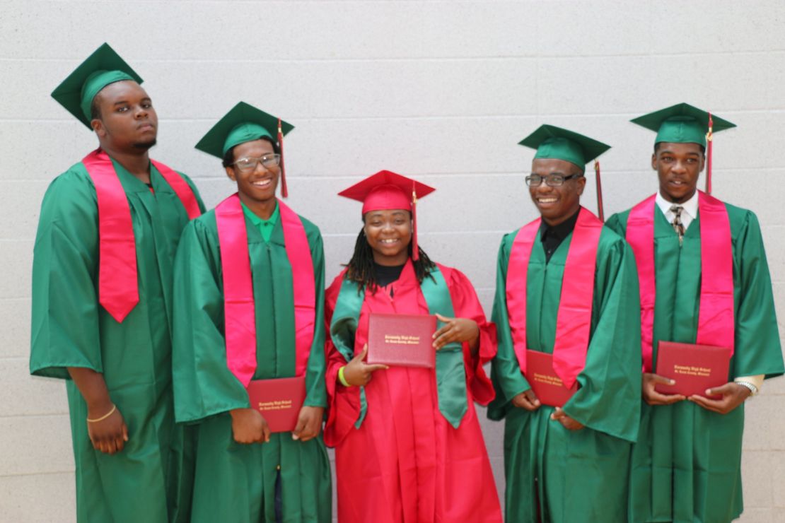 Michael Brown (far left) stands with fellow graduates at Normandy High School Summer graduation. 