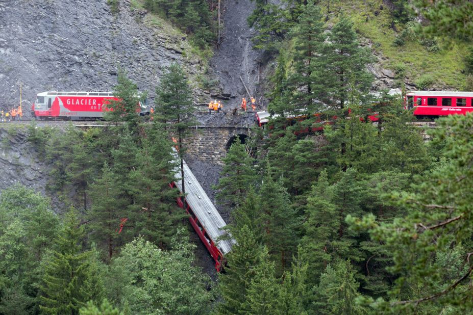 A derailed passenger train is pictured near Tiefencastel, Switzerland, on Wednesday, August 13. A landslide caused the train to partially derail in the Swiss Alps, injuring at least six people, regional police spokesman Peter Faerber said.