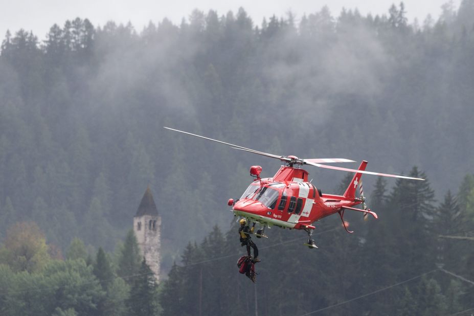 A helicopter transports emergency personnel to the passenger train accident.