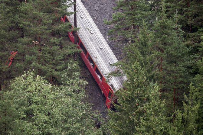 The derailed passenger train is pictured near Tiefencastel.