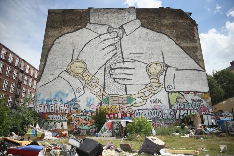 London isn't the only city to experience this phenomenon. Here, protestors lie under graffiti protesting against the gentrification of Berlin's Kreuzberg district.