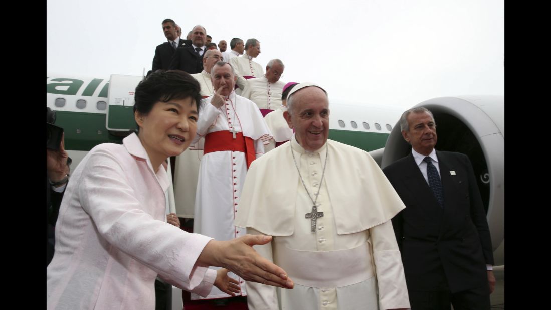 Pope Francis is escorted by Park upon his arrival at Seoul Military Airport in Seongnam.
