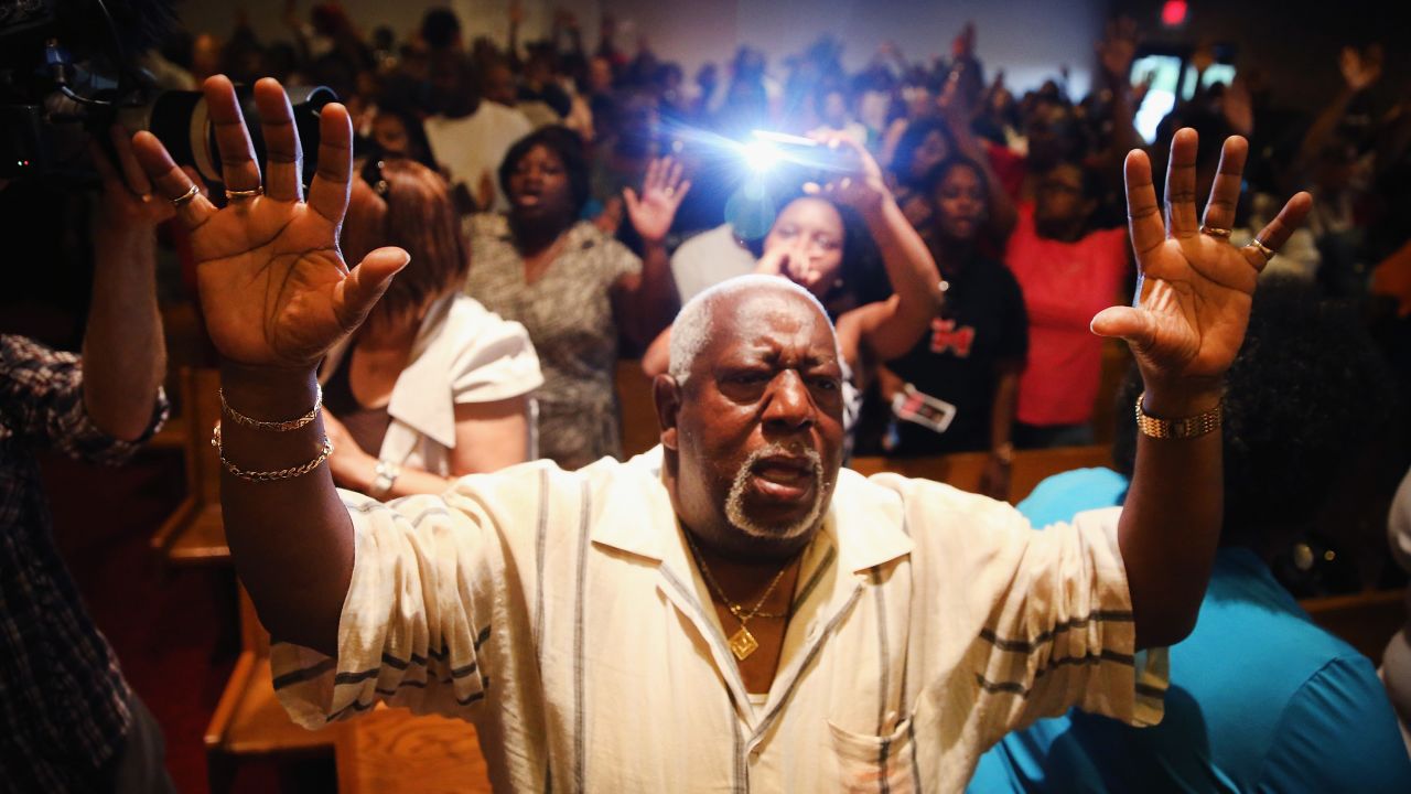 People congregate at the Greater St. Marks Family Church in St. Louis along with the family of Michael Brown and the Rev. Al Sharpton on August 12, 2014.