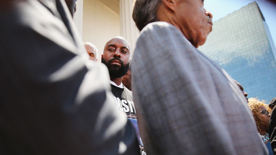 Michael Brown Sr. stands alongside Sharpton, right, during a news conference in St. Louis on August 12, 2014. 