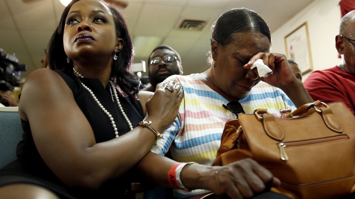 Phaedra Parks, left, comforts Desuirea Harris, the grandmother of Michael Brown, during a news conference in Jennings, Missouri, on August 11, 2014.
