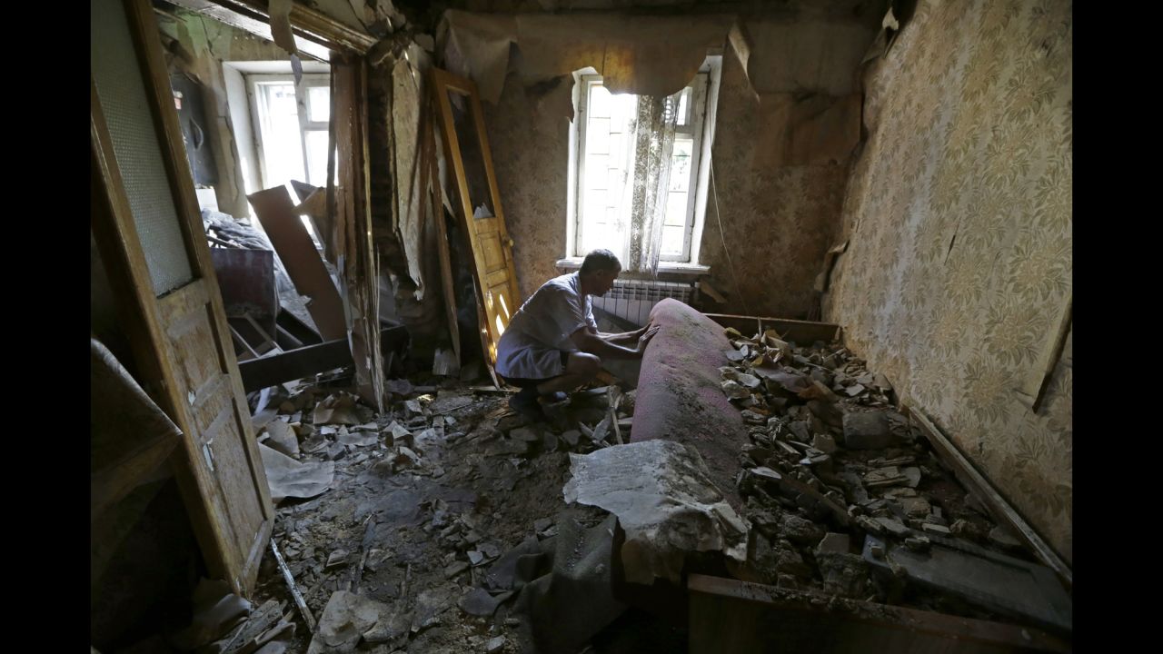 A man inspects damage at his house after a shelling in Donetsk on August 14. 
