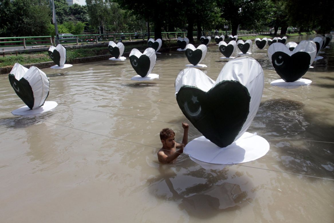 AUGUST 14 - LAHORE, PAKISTAN: A man fixes heart-shaped Pakistani flags in a canal a day ahead of the country's 68th Independence Day on  August 13. Pakistan will commemorate its independence from British colonial rule in 1947.