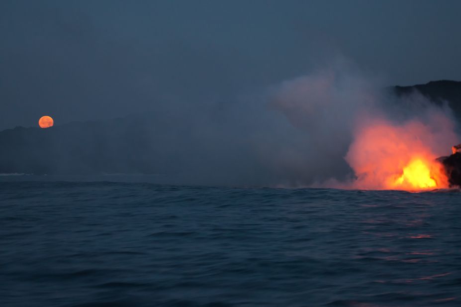 <a href="http://ireport.cnn.com/docs/DOC-967646">Jon Rosiska</a> photographed lava flowing into the ocean while traveling along the Big Island's coastline in April 2013.