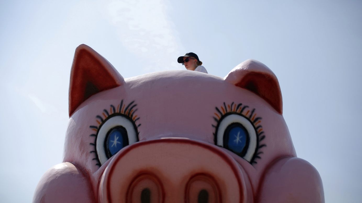 A worker is seen at the top of a ride at the Wisconsin State Fair in West Allis, Wisconsin, on Saturday, August 9. The fair, which has been around for 150 years, mixes agricultural exhibits with amusement rides.