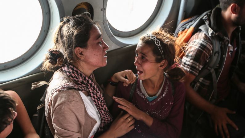Aziza Hamid, a 15-year-old Iraqi girl, cries for her father while she and other Yazidi people are flown to safety after a <a href="index.php?page=&url=http%3A%2F%2Fwww.cnn.com%2F2014%2F08%2F11%2Fworld%2Fgallery%2Fkurdistan-rescue-mission-mount-sinjar%2Findex.html">dramatic rescue operation</a> at Iraq's Mount Sinjar on August 11, 2014. A CNN crew <a href="index.php?page=&url=http%3A%2F%2Fwww.cnn.com%2F2014%2F08%2F11%2Fworld%2Fmeast%2Firaq-rescue-mission%2Findex.html">was on the flight,</a> which took diapers, milk, water and food to the site where as many as 70,000 people were trapped by ISIS. Only a few of them were able to fly back on the helicopter with the Iraqi Air Force and Kurdish Peshmerga fighters.