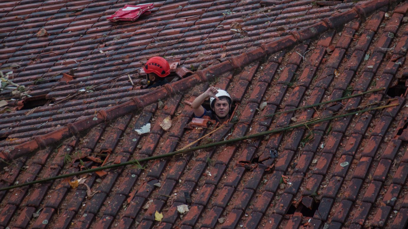 Emergency crews in Santos, Brazil, survey the damage of a <a href="http://www.cnn.com/2014/08/13/world/gallery/brazil-plane-crash/index.html">plane crash</a> that killed Brazilian presidential candidate Eduardo Campos and six others on Wednesday, August 13. The small plane was carrying Campos to a campaign stop when it crashed into a residential neighborhood, state-run Agencia Brasil reported. The country's Air Force said the crash was due to bad weather, but it is continuing to investigate the accident.