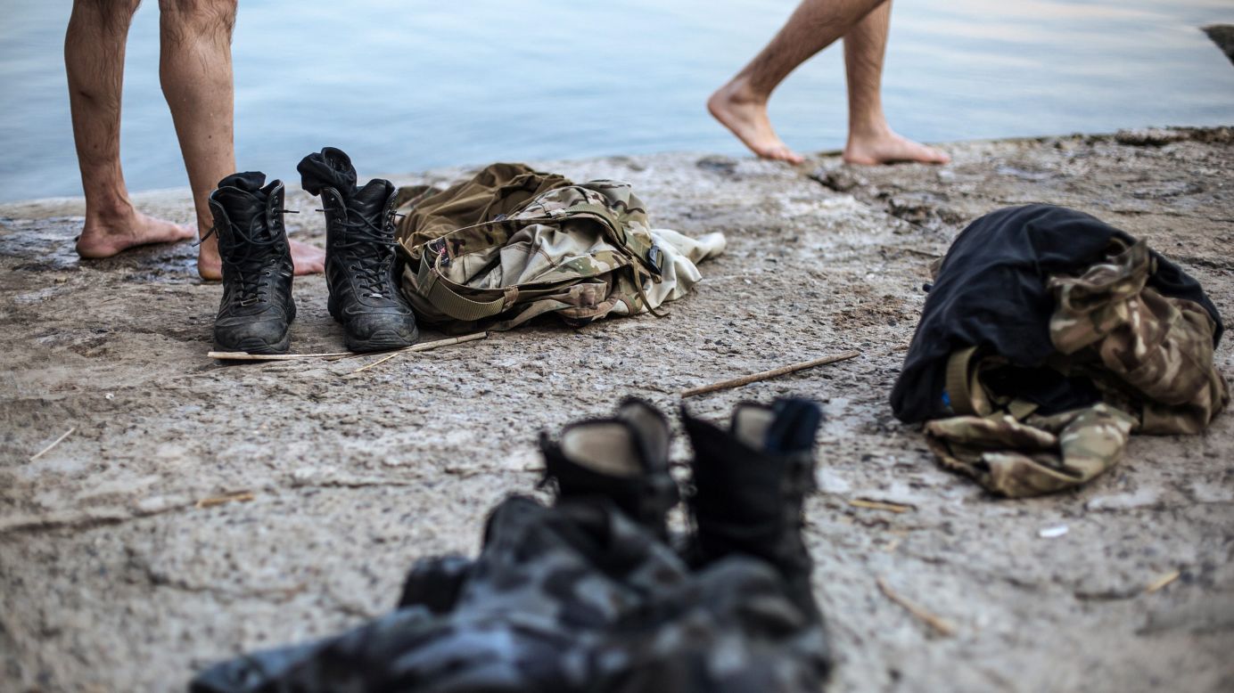 Clothes of some Ukrainian soldiers are placed nearby as they swim in a lake after fighting militants near Donetsk, Ukraine, on Friday, August 8. For months, Ukrainian government forces <a href="http://www.cnn.com/2014/08/07/europe/gallery/ukraine-crisis/index.html">have been fighting pro-Russian separatists</a> near the Russia border. The fighting has left more than 2,000 people dead since mid-April, according to "conservative" estimates from United Nations officials.