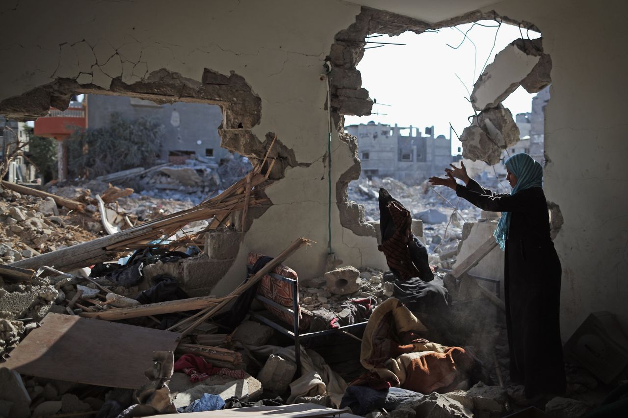 Islam El Masri begins to sort through the rubble of her destroyed home in Beit Hanoun, Gaza, on Thursday, August 14.