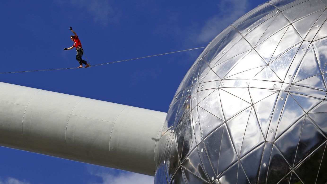A tightrope walker performs between two spheres of the <a href="http://atomium.be" target="_blank" target="_blank">Atomium monument</a> in Brussels, Belgium, on Monday, August 11. The 335-foot-tall structure is shaped like a unit cell of an iron crystal that has been magnified about 165 billion times.