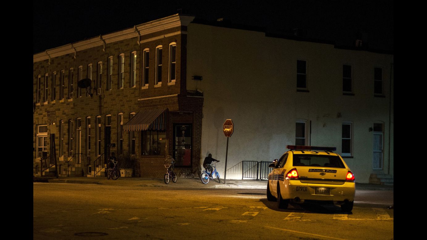 Police patrol a residential neighborhood in east Baltimore minutes after a new curfew law took effect Friday, August 8. Mayor Stephanie Rawlings-Blake said the measure is aimed at getting children off the streets before they are put in danger. <a href="http://www.cnn.com/2014/08/08/world/gallery/week-in-photos-0808/index.html">See last week in 34 photos</a>