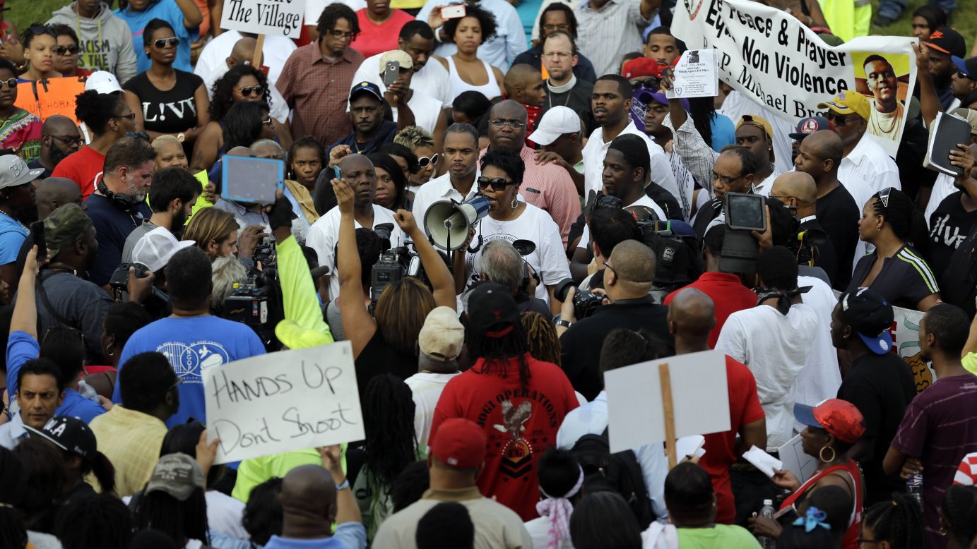 The Rev. Traci Blackmon uses a megaphone to talk to a large group of demonstrators on August 14, 2014.