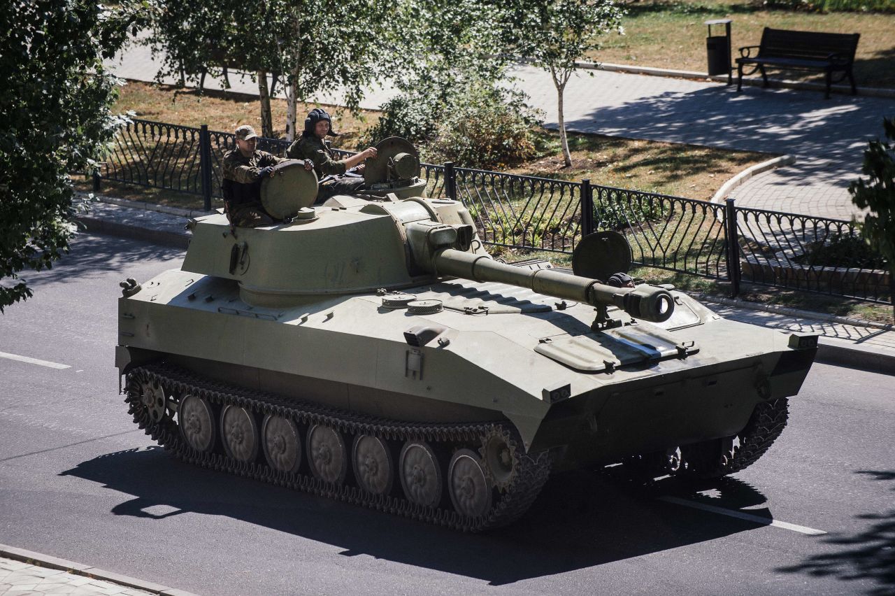 A tank belonging to pro-Russian rebels moves along a street in Donetsk on August 15.