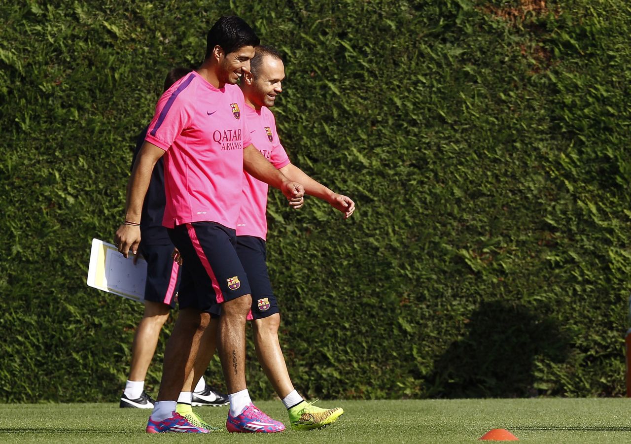 Luis Suarez has completed his first training session with his Barcelona teammates. The Uruguayan lost his appeal to have his four-month "biting ban" reduced by the <a href="http://cnn.com/2014/08/14/sport/football/luis-suarez-biting-ban-cas-barcelona/index.html">Court of Arbitration for Sport</a> on Thursday but the restriction on him training with his new teammates was lifted. The former Liverpool player, seen here with Andreas Iniesta, cannot play competitive football for Barcelona until the end of October.    